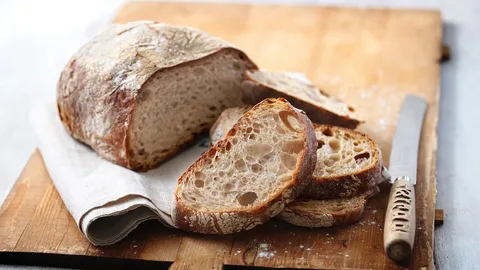 Freshly baked sourdough bread with a crispy crust and airy crumb.