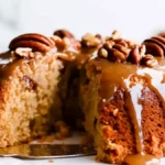 Pecan Praline Cake with praline icing and chopped pecans.