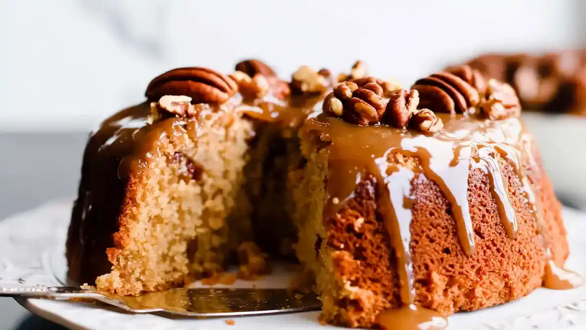 Pecan Praline Cake with praline icing and chopped pecans.