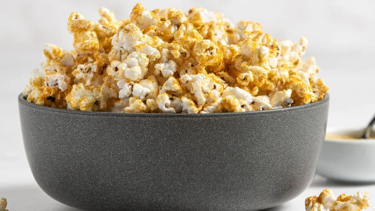 A bowl of popcorn sprinkled with nutritional yeast, garlic, and onion powder.