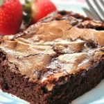 Chocolate pecan bar served with fresh strawberries on a plate