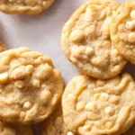 Freshly baked White Chocolate Macadamia Nut Cookies on a cooling rack.