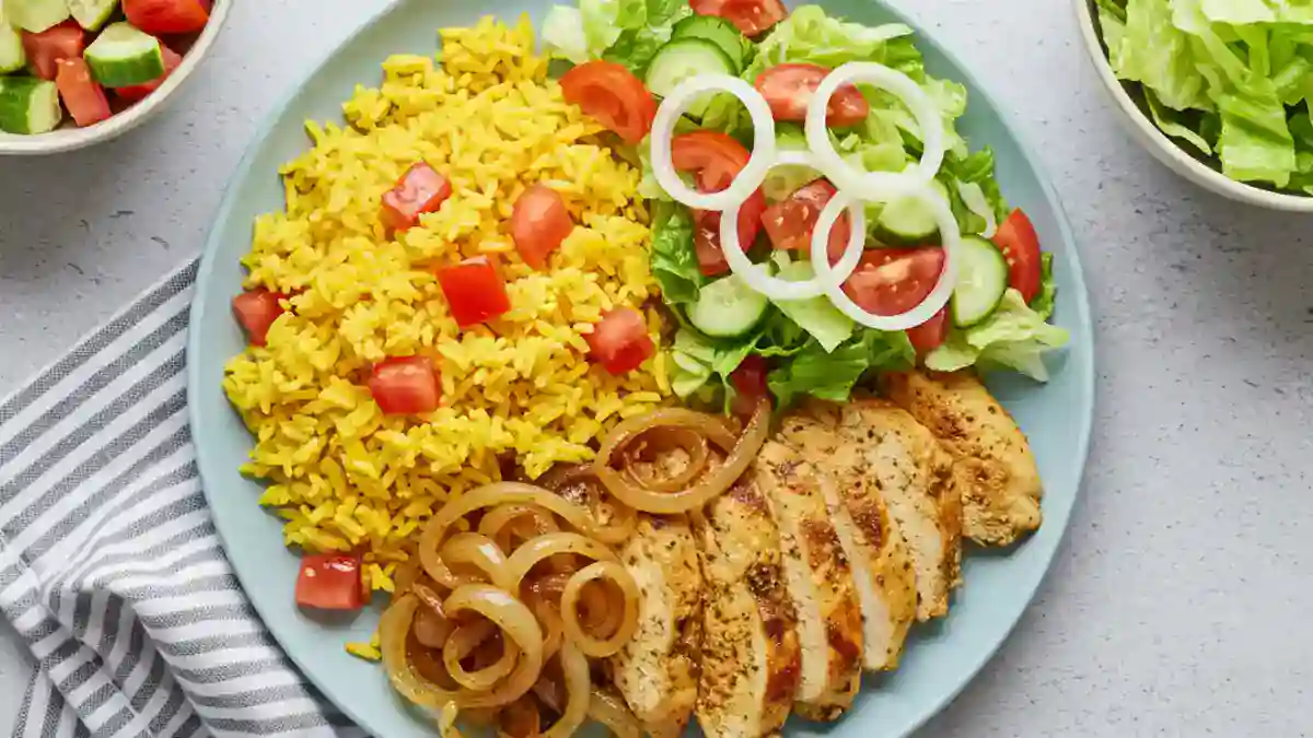 Healthy chicken shawarma bowl with turmeric rice, grilled chicken and fresh vegetables