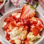Strawberry cheesecake dump cake with cream cheese, yellow cake mix, and pie filling.