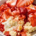 Strawberry cheesecake dump cake with cream cheese, yellow cake mix, and pie filling.