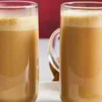 Homemade Eggnog Latte featuring espresso, eggnog, and frothed milk in a festive setting