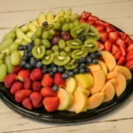 Colorful fruit platter featuring strawberries, grapes, and seasonal fruits ready for any event.