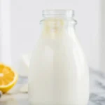 Homemade buttermilk mixture with milk and vinegar in a measuring cup