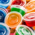 Colorful jello shots served in clear cups, perfect for parties and gatherings.