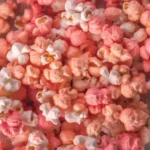 Colorful candy popcorn in a bowl, perfect for parties and sweet cravings.