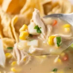 Delicious creamy white chicken chili made in a crockpot with beans, spices, and chicken.