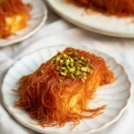 Delicious Knafeh with layers of crispy pastry and sweet cheese soaked in syrup.